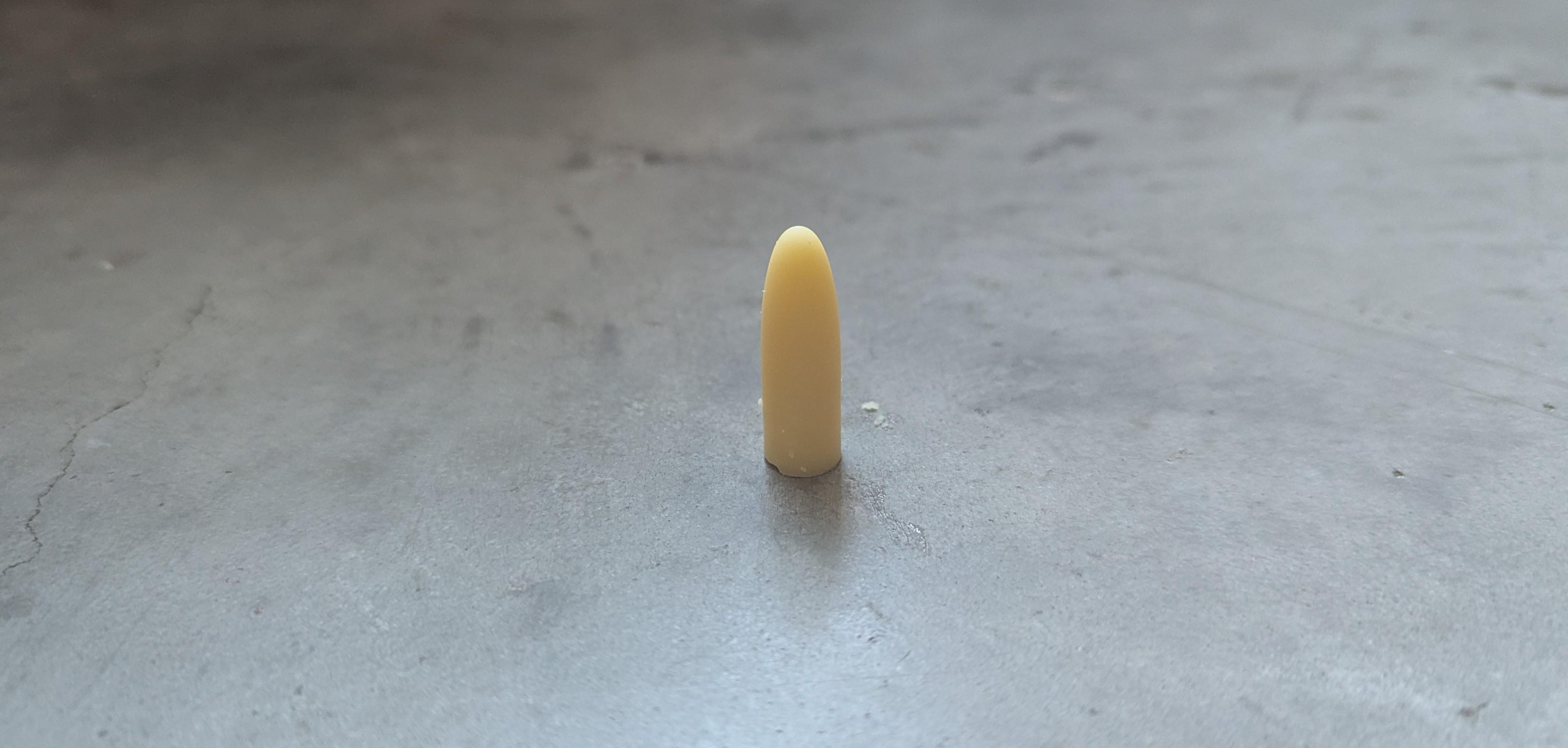 a light yellow pessary on a concrete floor